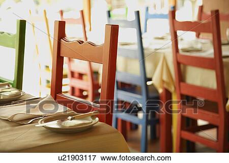 Different colored chairs at tables set for dining in Lisbon, Portugal. View Large Photo Image Stock Photo - Different colored chairs at tables set for dining in Lisbon, Portugal.. Fotosearch
