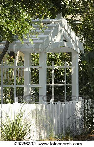 Garden arbor with white picket fence. View Large Photo Image Stock Image - Garden arbor with white picket fence.. Fotosearch