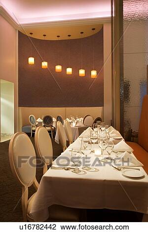 Long table in restaurant with place settings. View Large Photo Image Stock Image - Long table in restaurant with place settings.. Fotosearch