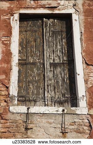 Worn building with window with closed wooden shutters in Venice, Italy. View Large Photo Image Stock Photo - Worn building with window with closed wooden shutters in Venice, Italy.. Fotosearch