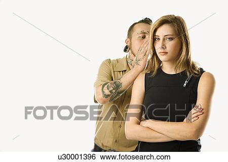 Caucasian mid-adult man whispering into ear of teen female. View Large Photo Image Stock Photograph - Caucasian mid-adult man whispering into ear of teen female.. Fotosearch