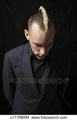 Man in suit with mohawk looking down View Large Photo Image Picture - Man in suit with mohawk looking down . Fotosearch
