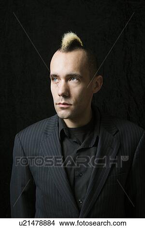 Portrait of Caucasian man in suit with mohawk against black background. View Large Photo Image Picture - Portrait of Caucasian man in suit with mohawk against black background.. Fotosearch