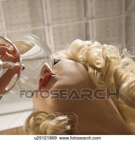 Woman drinking a martini View Large Photo Image Stock Photo - Woman drinking a martini. Fotosearch