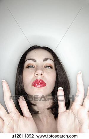 Stock Image - Woman holding hands toward viewer. Fotosearch