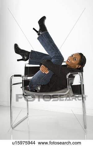 Woman lounging in chair smiling View Large Photo Image Picture - Woman lounging in chair smiling. Fotosearch