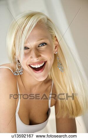 Portrait of attractive blonde young adult woman smiling and looking at viewer View Large Photo Image Stock Photo - Portrait of attractive blonde young adult woman smiling and looking at viewer. Fotosearch