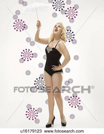 Attractive Caucasian woman wearing retro swimsuit in pinup pose with umbrella. View Large Photo Image Stock Image - Attractive Caucasian woman wearing retro swimsuit in pinup pose with umbrella.. Fotosearch