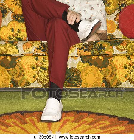 Caucasian mid-adult man sitting on colorful retro sofa looking bored. View Large Photo Image Stock Image - Caucasian mid-adult man sitting on colorful retro sofa looking bored.. Fotosearch