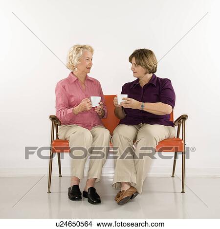 Caucasian middle aged woman and senior woman drinking coffee. View Large Photo Image Picture - Caucasian middle aged woman and senior woman drinking coffee.. Fotosearch