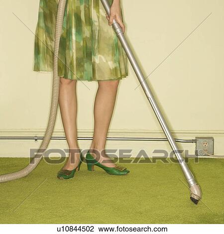 Close-up of Caucasian female legs with vacuum extension against green retro carpet. View Large Photo Image Stock Image - Close-up of Caucasian female legs with vacuum extension against green retro carpet.. Fotosearch