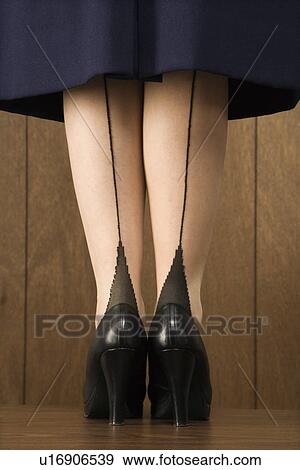 Stock Photo - Close-up shot of Caucasian female in skirt with black heels. . Fotosearch