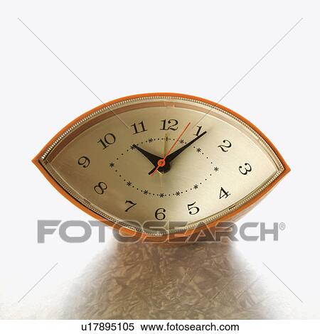 Still life of orange eye-shaped vintage clock on table. View Large Photo Image Stock Photography - Still life of orange eye-shaped vintage clock on table.. Fotosearch