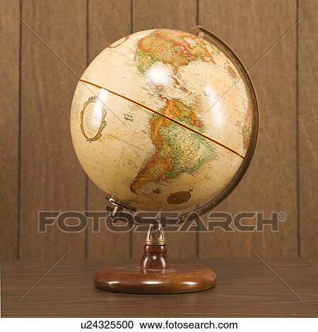 Still life shot of a vintage world globe sitting on a desk View Large Photo Image Stock Image - Still life shot of a vintage world globe sitting on a desk. Fotosearch
