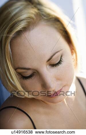 Caucasian mid-adult blonde woman looking down. View Large Photo Image Stock Photo - Caucasian mid-adult blonde woman looking down.. Fotosearch