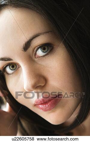 Stock Photo - Close up of Caucasian young adult woman looking at viewer.. Fotosearch