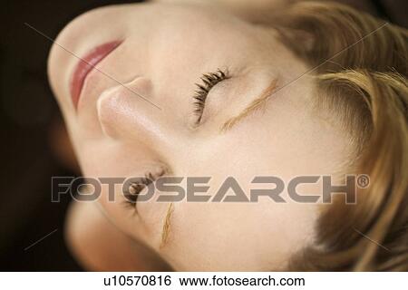 Close up portrait of pretty redhead woman with eyes closed View Large Photo Image Stock Photograph - Close up portrait of pretty redhead woman with eyes closed. Fotosearch