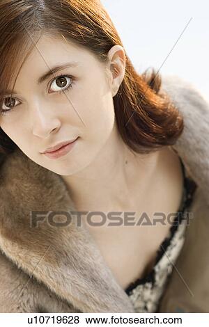 Stock Photo - Head and shoulder portrait of attractive young redhead Caucasian woman.. Fotosearch