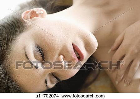 Portrait of an attractive woman with hand on shoulder. View Large Photo Image Picture - Portrait of an attractive woman with hand on shoulder.. Fotosearch