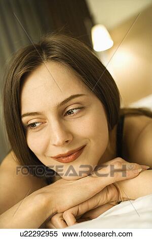 Portrait of Caucasian mid-adult woman smiling with head resting on hands. View Large Photo Image Stock Photography - Portrait of Caucasian mid-adult woman smiling with head resting on hands.. Fotosearch