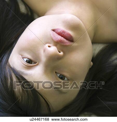 Woman lying in bed making eye contact View Large Photo Image Stock Photo - Woman lying in bed making eye contact. Fotosearch