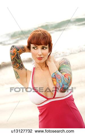 Attractive tattooed woman on beach View Large Photo Image Stock Image - Attractive tattooed woman on beach . Fotosearch