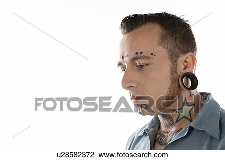 Caucasian mid-adult man with tattoos and piercings. View Large Photo Image Stock Image - Caucasian mid-adult man with tattoos and piercings.. Fotosearch