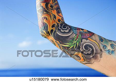 Close up of tattooed woman's arm with Pacific Ocean in background View Large Photo Image Stock Photo - Close up of tattooed woman's arm with Pacific Ocean in background . Fotosearch