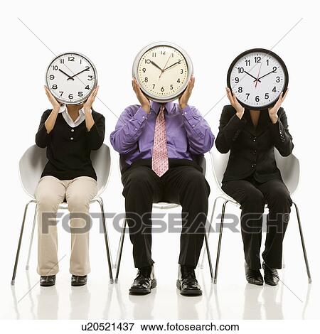 Stock Photo - Business people in chairs holding clocks over their faces. Fotosearch