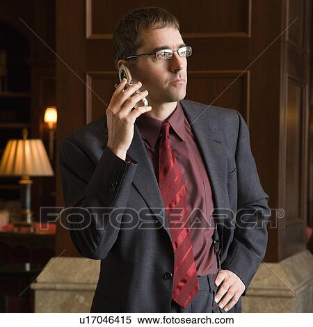 Stock Photography - Caucasian mid adult buisinessman on cell phone.. Fotosearch