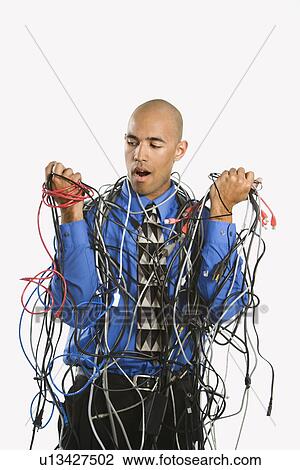 Confused businessman tangled in cables View Large Photo Image Stock Image - Confused businessman tangled in cables. Fotosearch