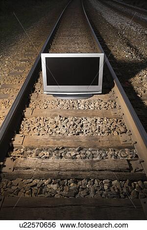 Flat panel television set on railroad tracks at night View Large Photo Image Stock Photograph - Flat panel television set on railroad tracks at night. Fotosearch