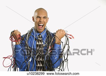 Frustrated businessman wrapped in cords View Large Photo Image Stock Photo - Frustrated businessman wrapped in cords. Fotosearch