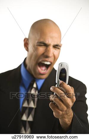 Stock Photo - Man in suit yelling at cellphone. Fotosearch