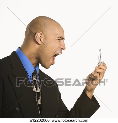 Profile of angry businessman shouting into phone View Large Photo Image Stock Photograph - Profile of angry businessman shouting into phone. Fotosearch