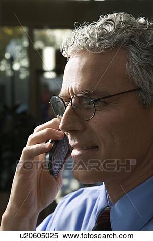 Stock Photography - Profile shot of man on phone. Fotosearch
