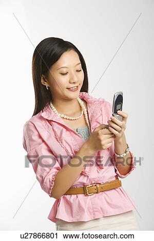 Smiling and text messaging View Large Photo Image Stock Image - Smiling and text messaging. Fotosearch