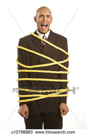 Upset Businessman Tied Up in Rope View Large Photo Image Stock Image - Upset Businessman Tied Up in Rope. Fotosearch
