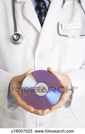 Close up of physician holding compact disc. View Large Photo Image Stock Image - Close up of physician holding compact disc.. Fotosearch