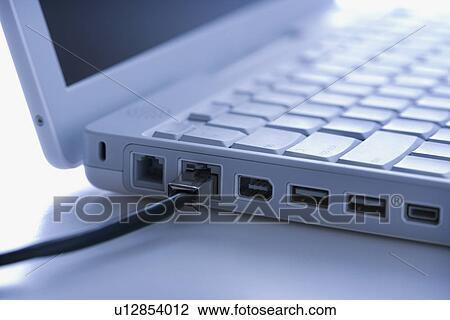Stock Image - Data wire connected to laptop . Fotosearch