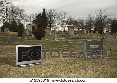 Flat panel television set in cemetery next to headstone View Large Photo Image Stock Photo - Flat panel television set in cemetery next to headstone. Fotosearch