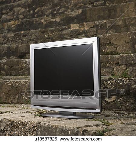 Flat panel television set in front of gray brick wall. View Large Photo Image Stock Photography - Flat panel television set in front of gray brick wall.. Fotosearch