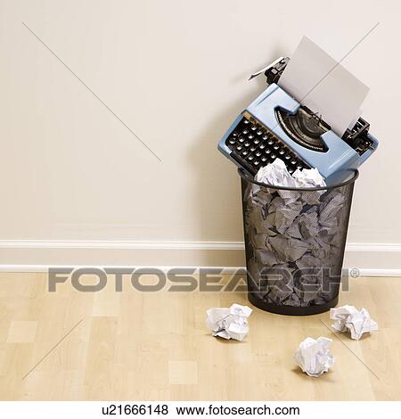 Stock Photo - Old fashioned typewriter in trash can surrounded by crumpled up paper.. Fotosearch