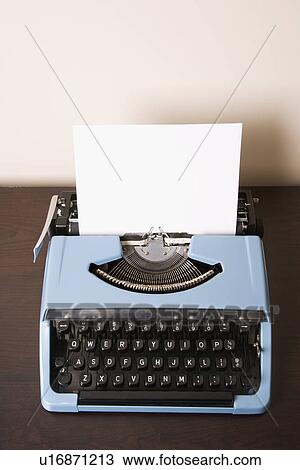 Stock Image - Still life of blank sheet of paper in an old fashioned typewriter. Fotosearch