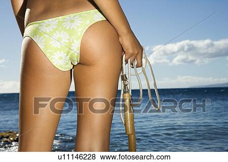 Close up of derriere of a young adult female holding jump rope in swimsuit on beach View Large Photo Image Stock Photo - Close up of derriere of a young adult female holding jump rope in swimsuit on beach . Fotosearch