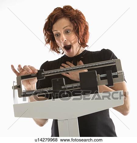 Pregnant Caucasian mid-adult woman surprised by her weight shown on scale. View Large Photo Image Stock Photo - Pregnant Caucasian mid-adult woman surprised by her weight shown on scale.. Fotosearch