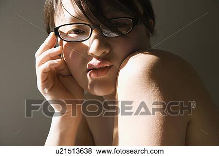 Stock Photo - Head and shoulder portrait of pretty young woman wearing eyeglasses. Fotosearch