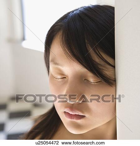 Stock Image - Portrait of bare pretty young Asian woman with eyes closed.. Fotosearch