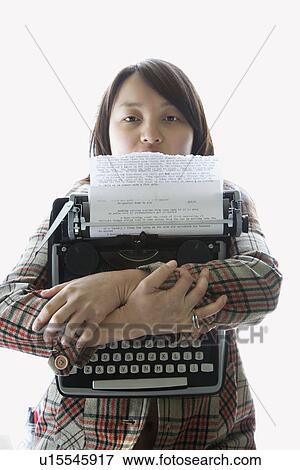 Stock Photo - Pretty young Asian woman holding typewriter.. Fotosearch