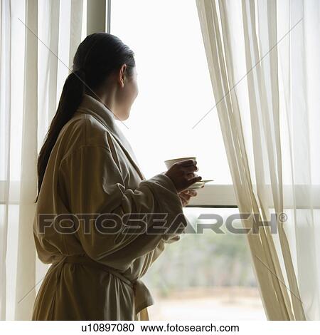 Taiwanese mid adult woman in bathrobe looking out window. View Large Photo Image Stock Image - Taiwanese mid adult woman in bathrobe looking out window.. Fotosearch
